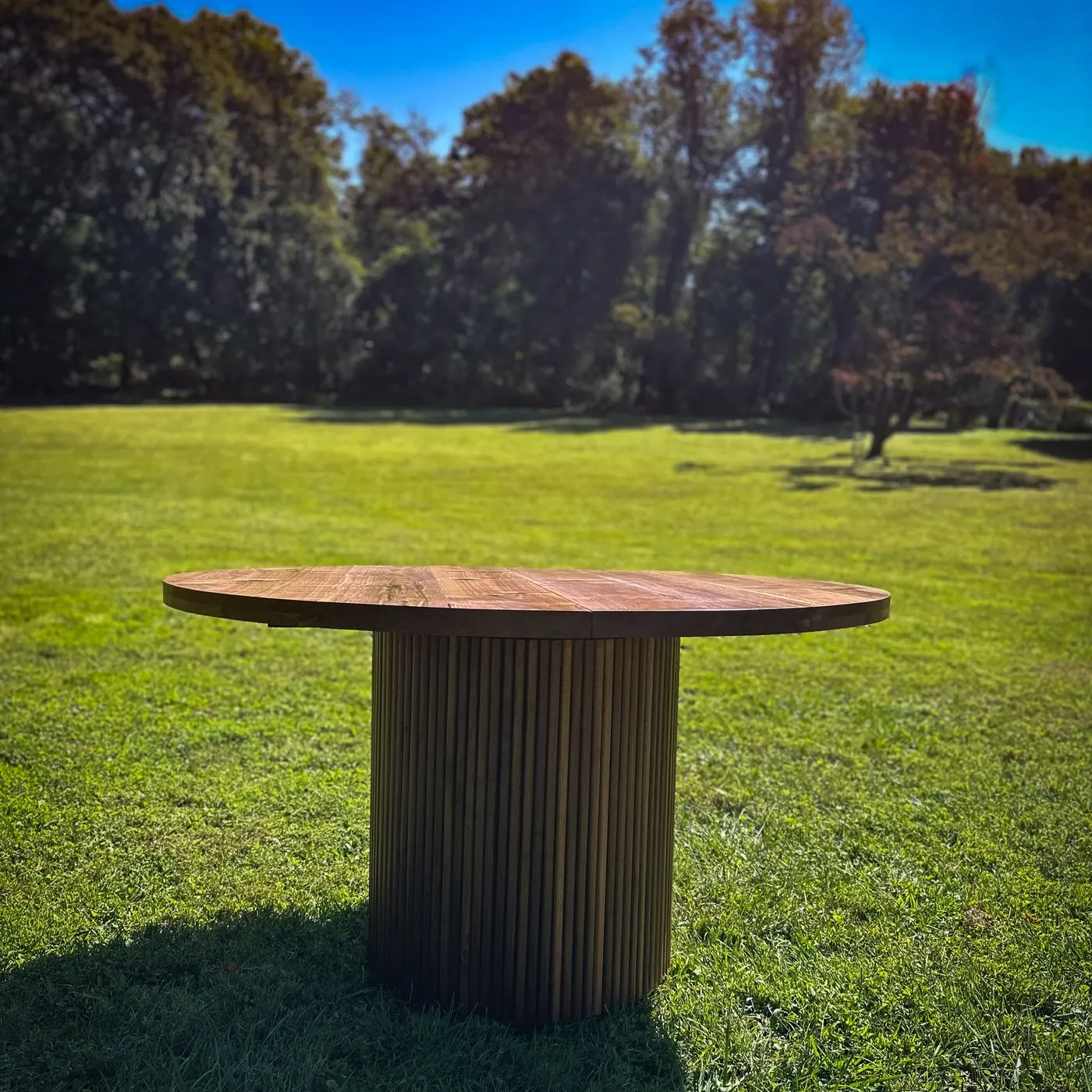 Round reclaimed wood dining table with a fluted pedestal base, handmade by Baltimore furniture maker Tyler Jones