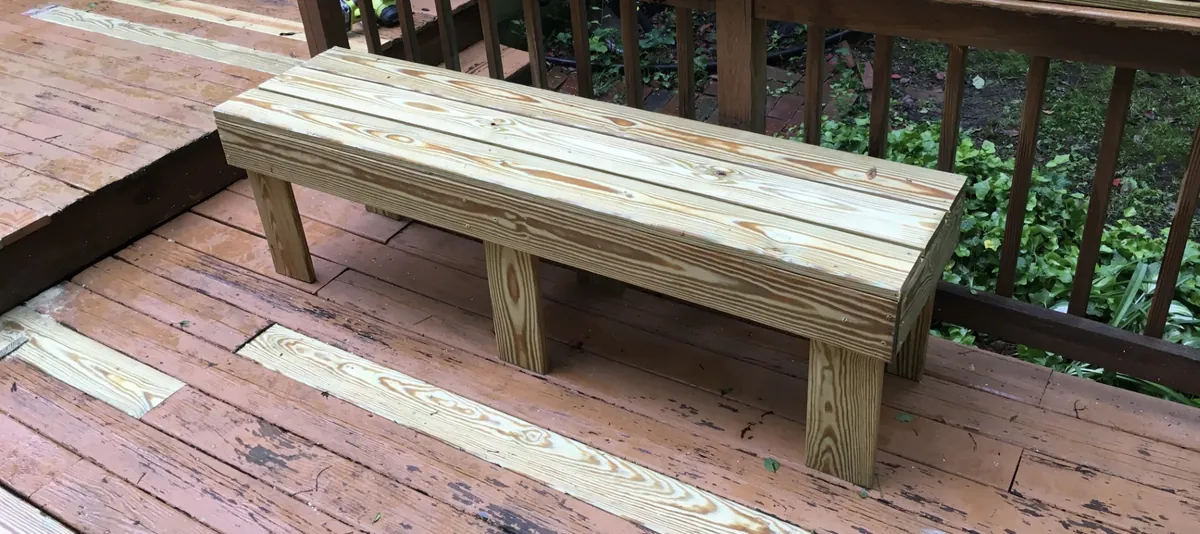 Simple wooden outdoor bench on a deck, built by Baltimore furniture maker Tyler Jones