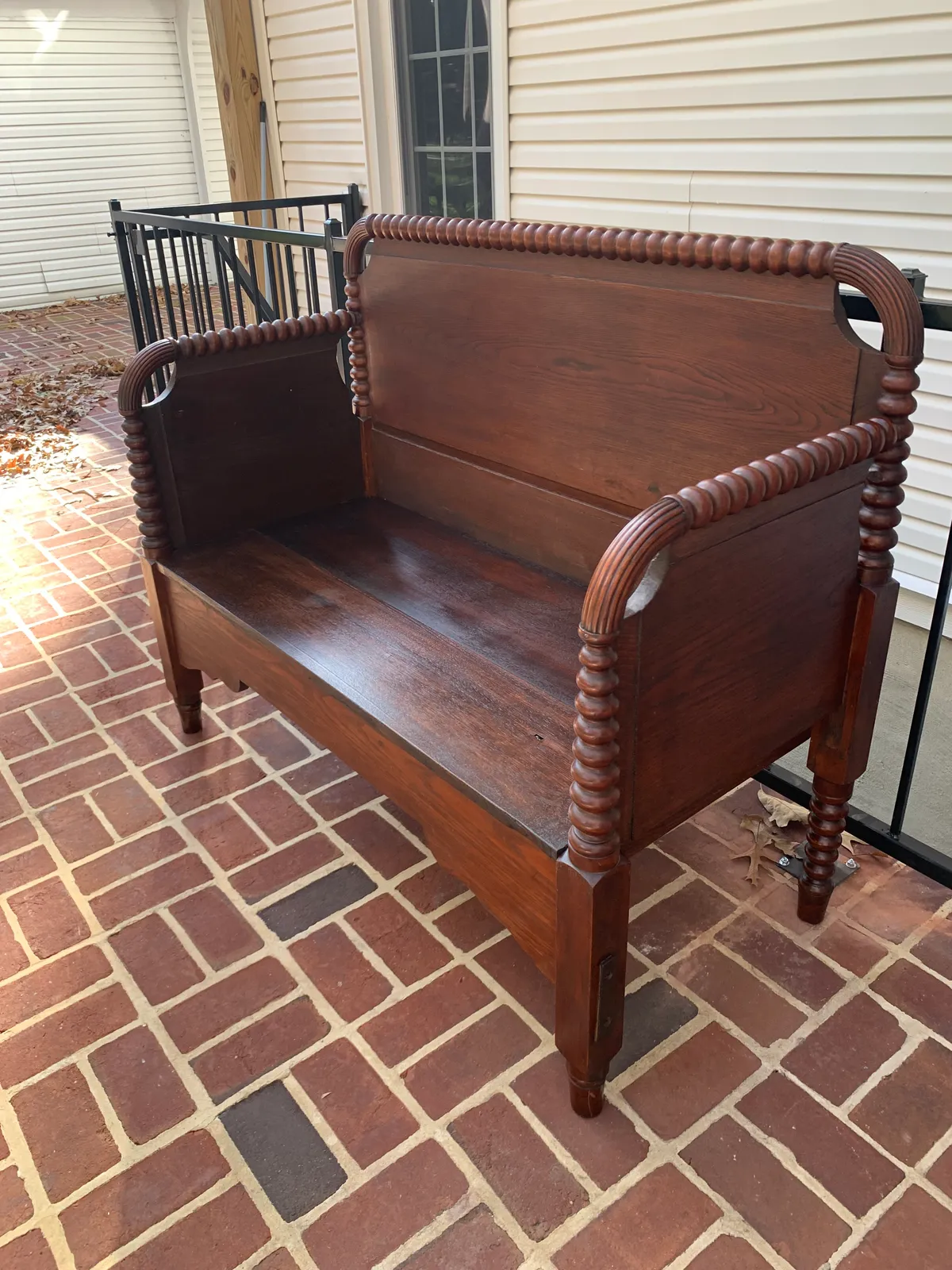 Antique spool-turned bed frame rebuilt into a wooden hall bench by Baltimore furniture maker Tyler Jones